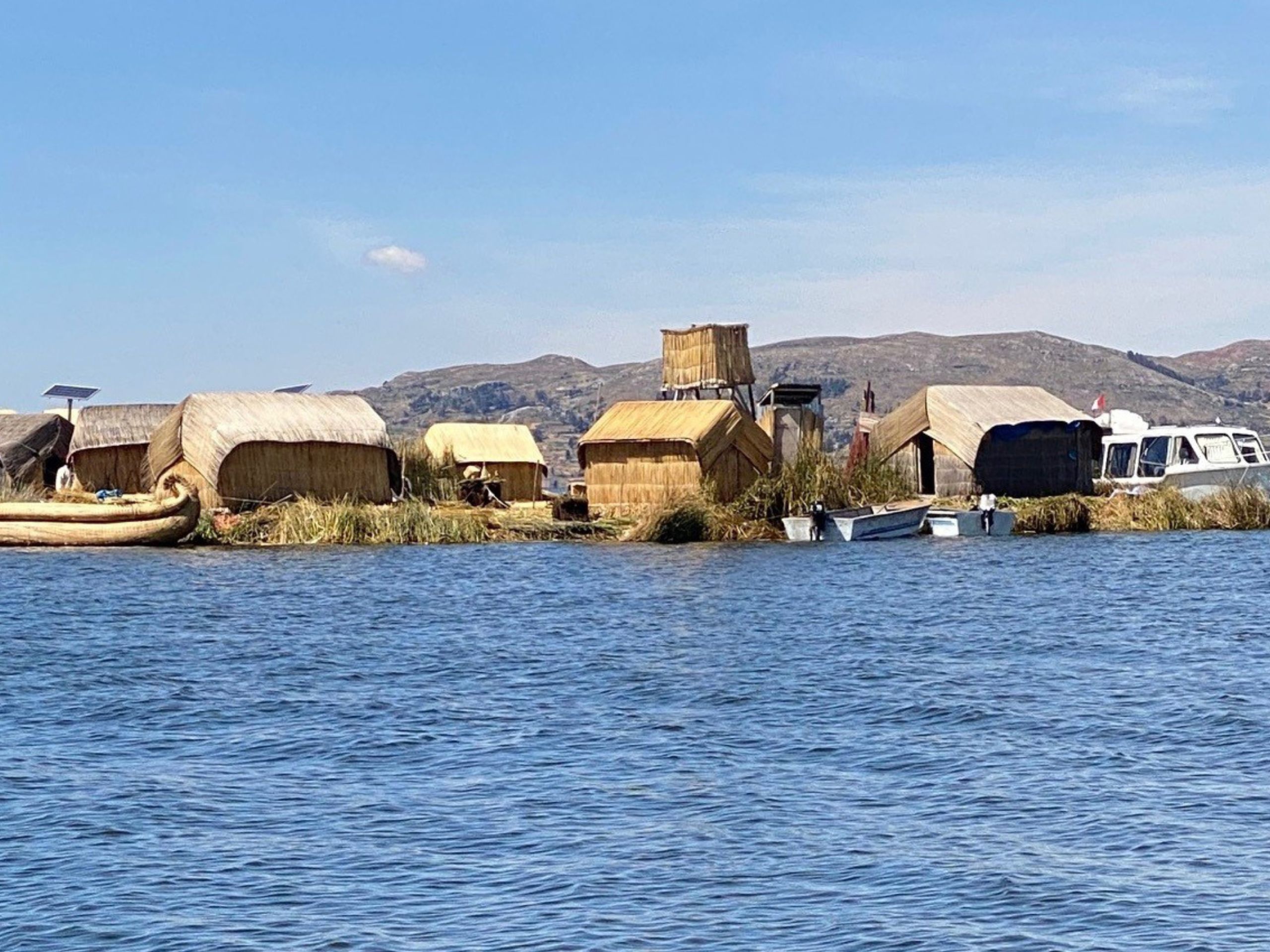 what's the story, Lake Titicaca in peru with structure and mountains