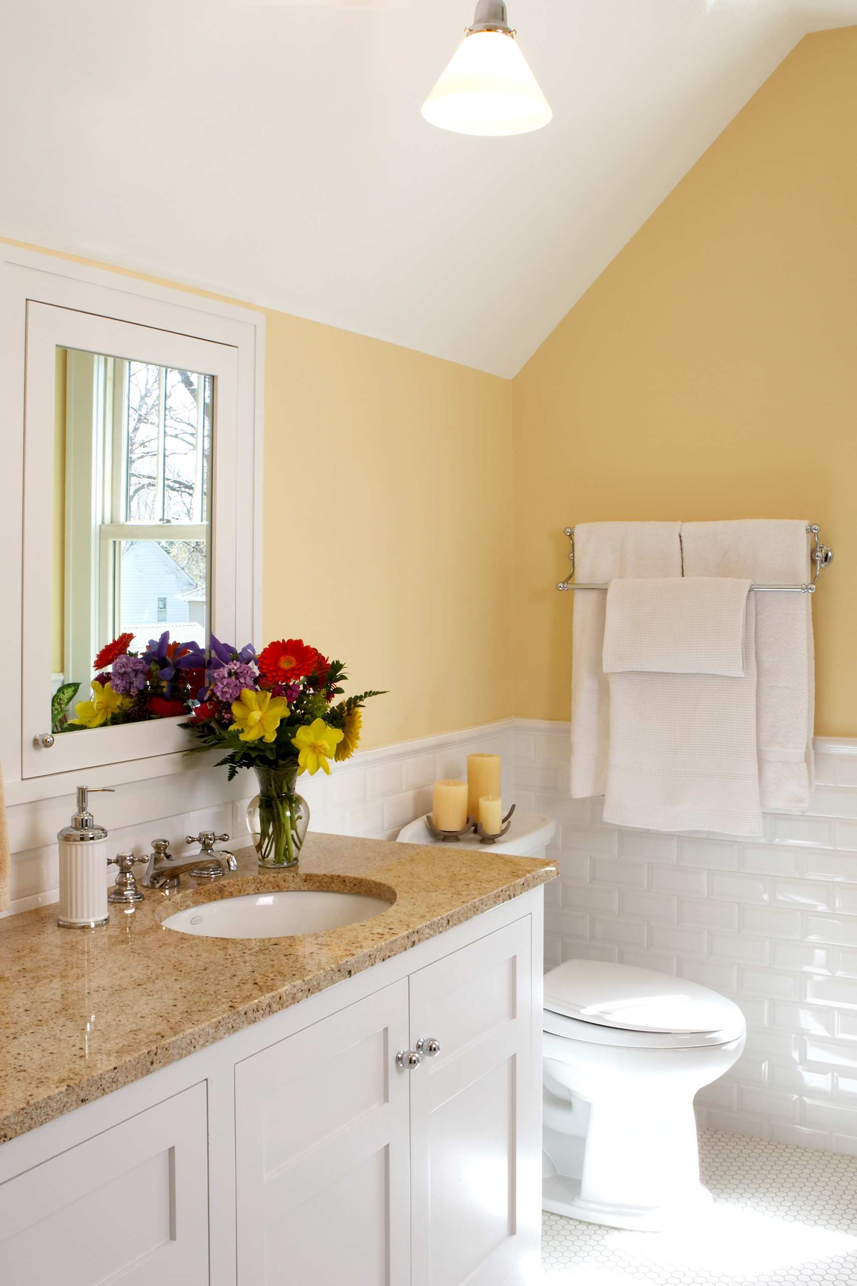 Minneapolis attic design with sunny yellow bathroom and white tile