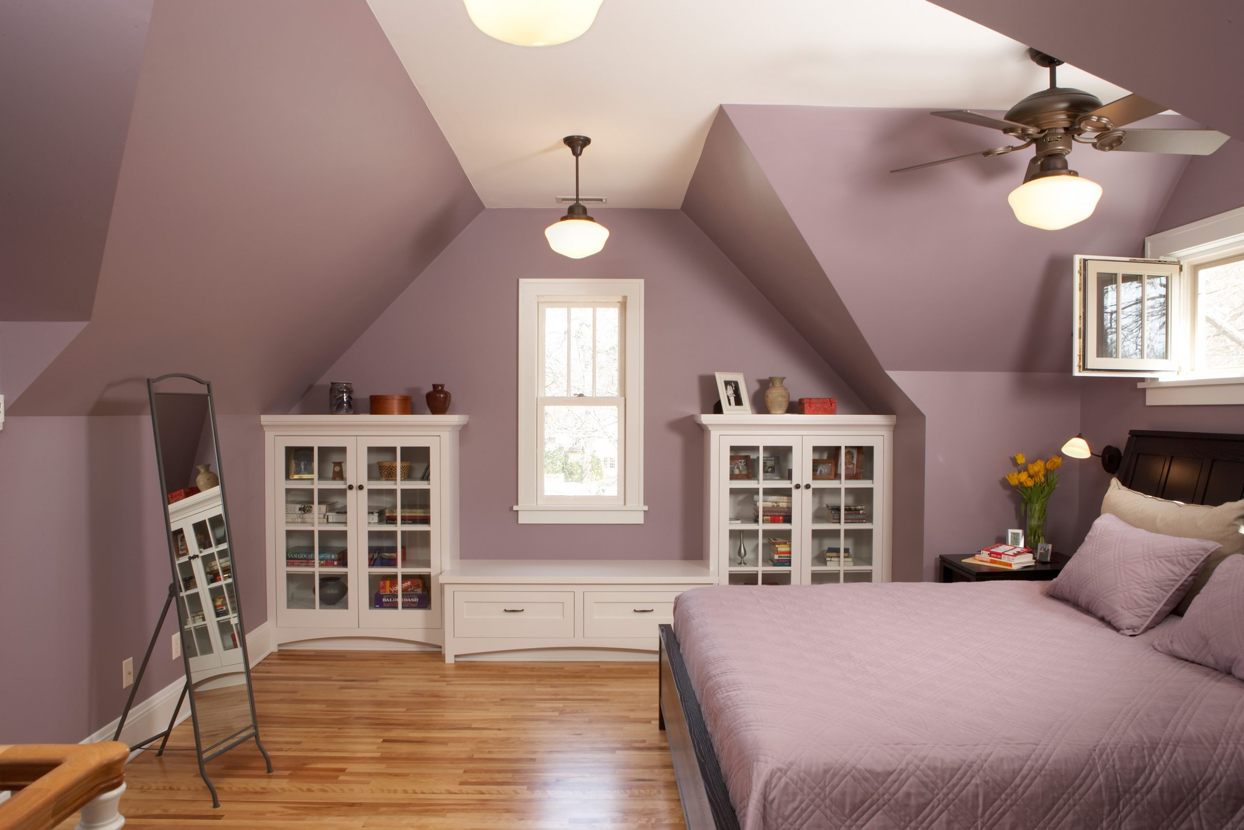 Charming Minneapolis attic design purple bedroom with white cabinets