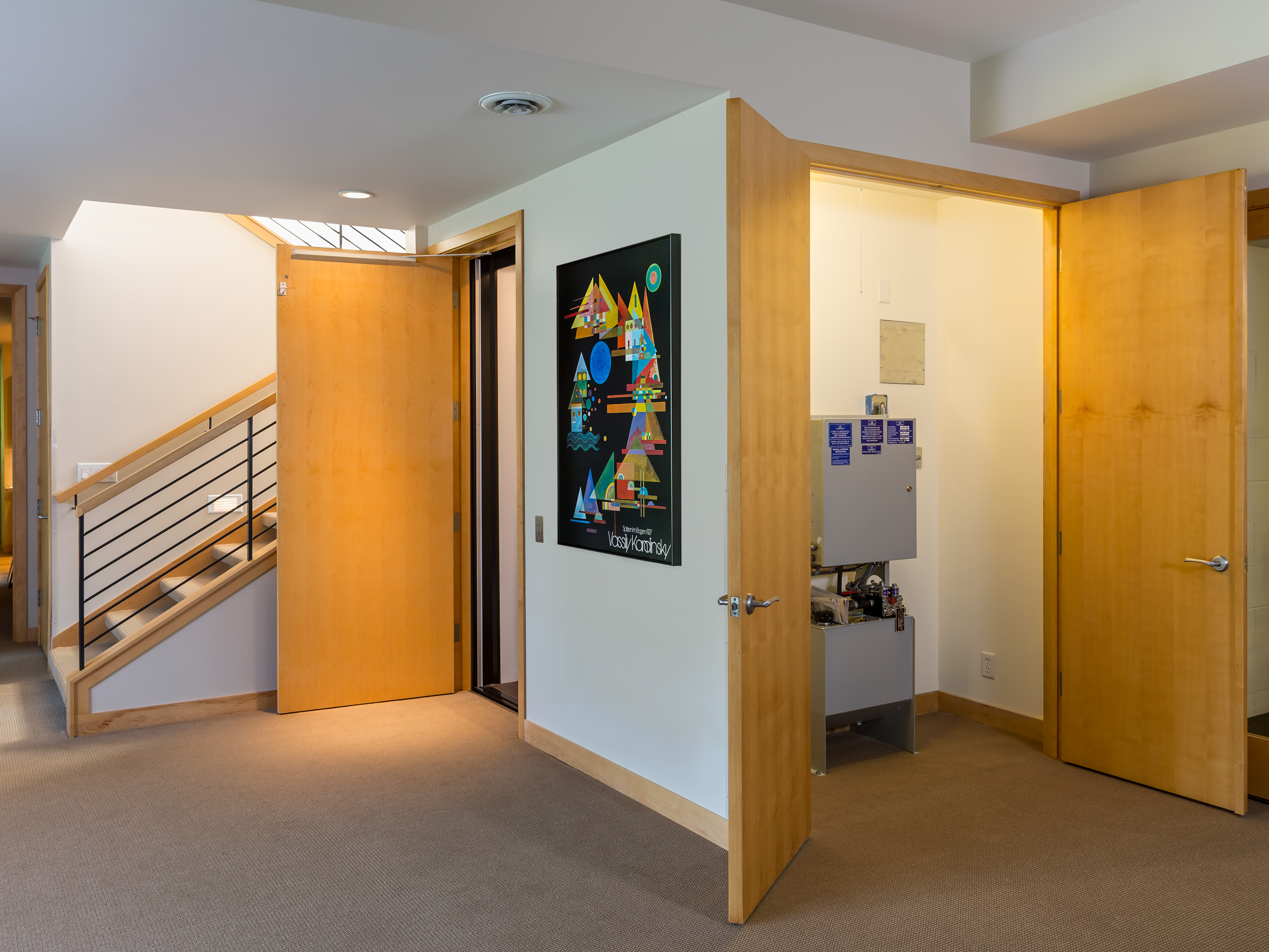 A basement renovation with an elevator lift and stairway 