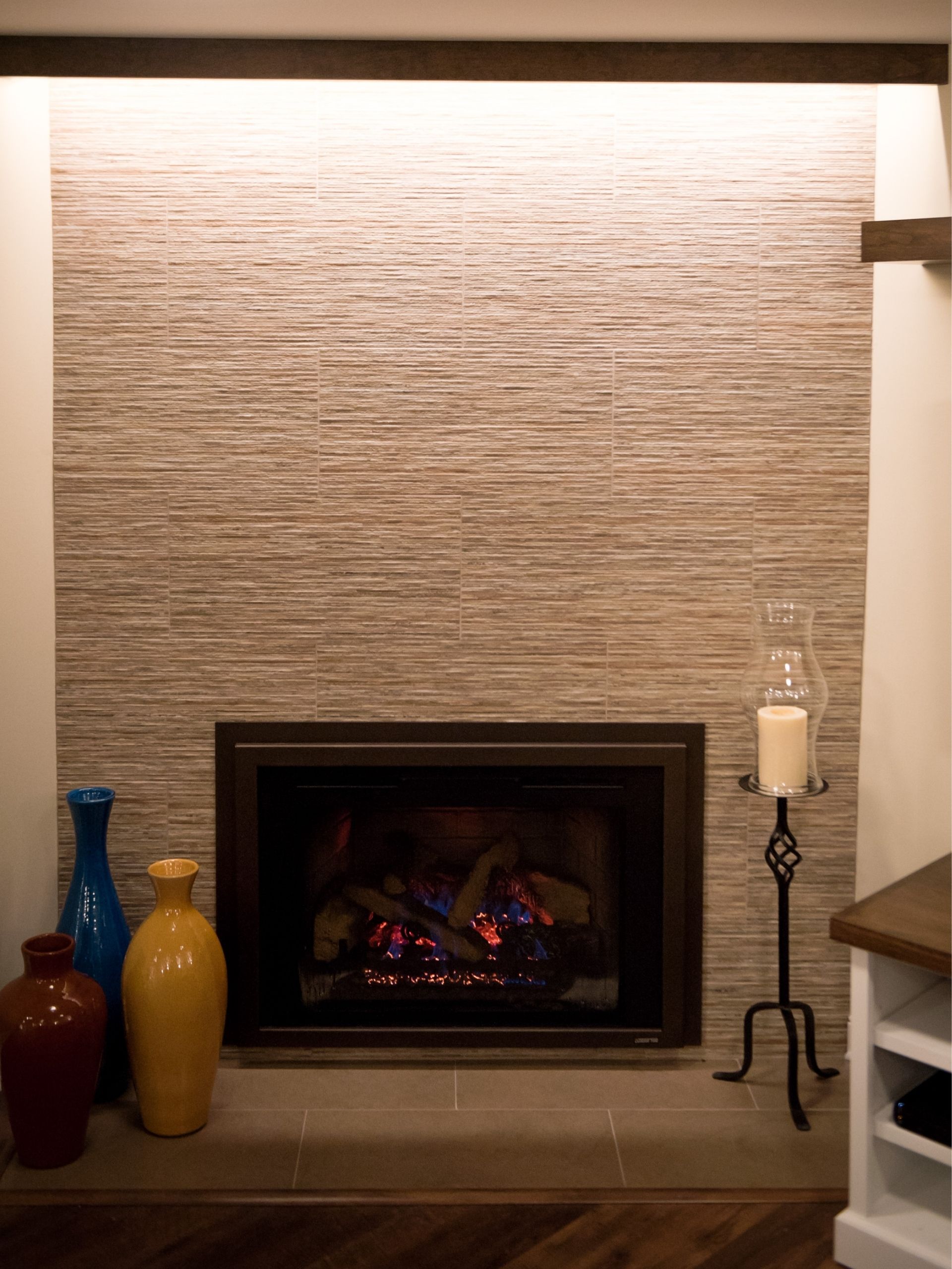 basement remodeling ideas: Basement fireplace, fire lit, candle and vases