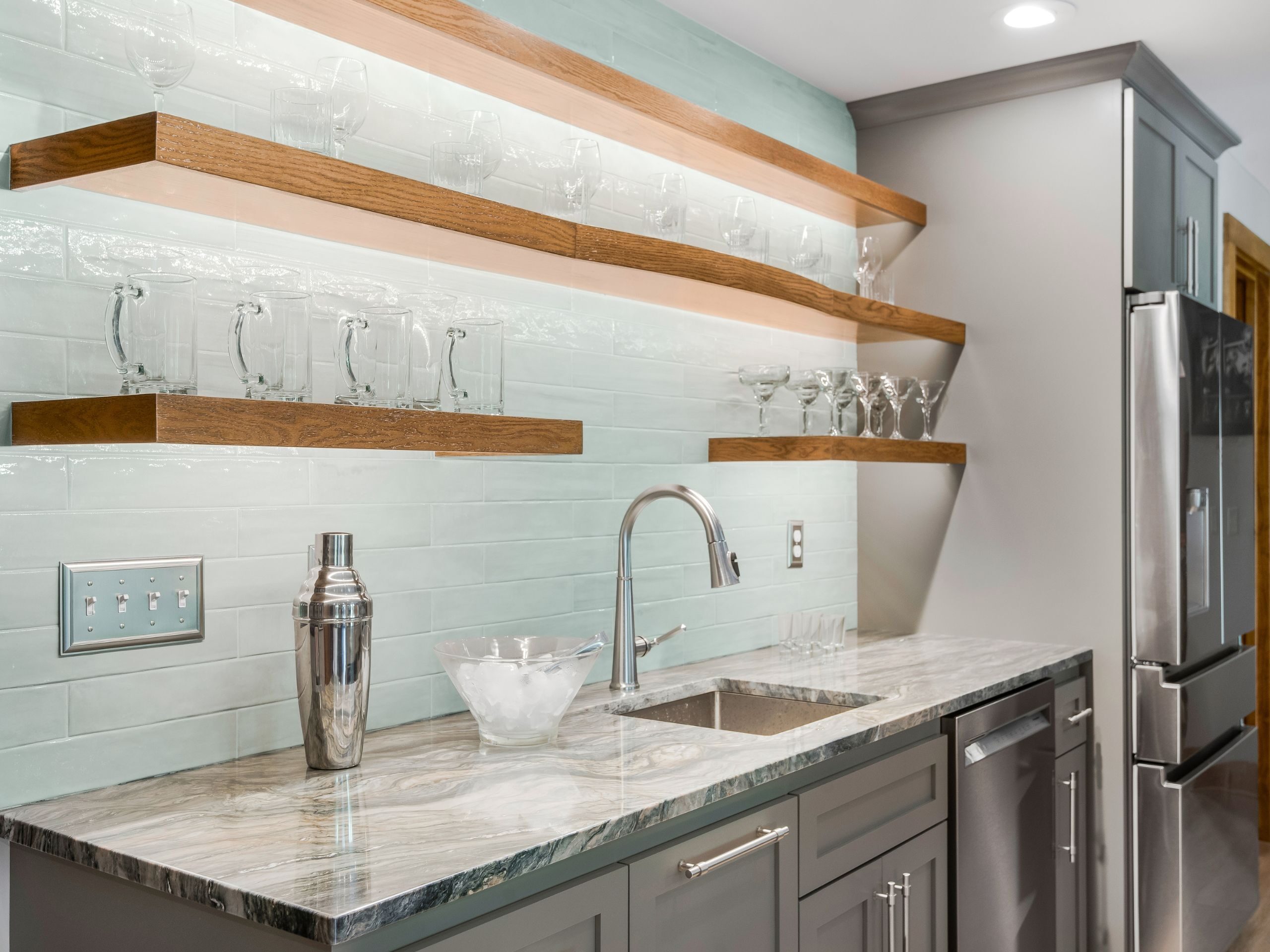 a bar counter with sink and floating shelves