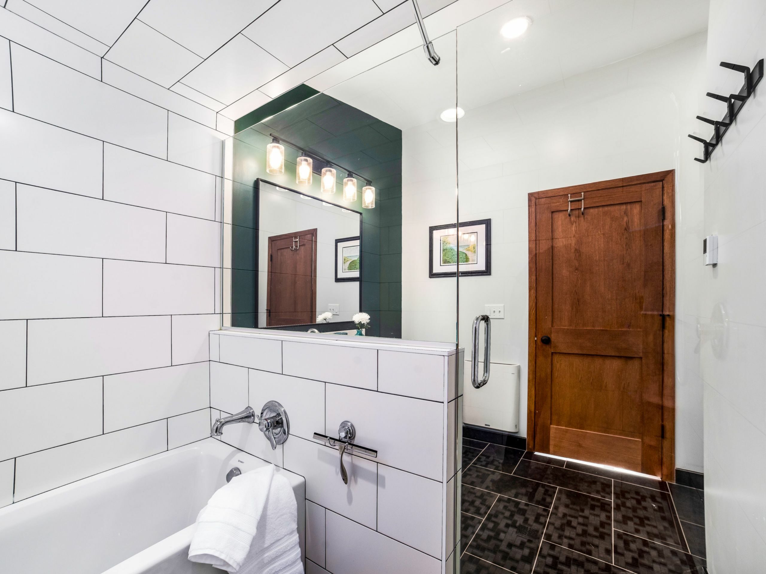 bathroom expansion remodel with tub in shower, bathroom door. hooks