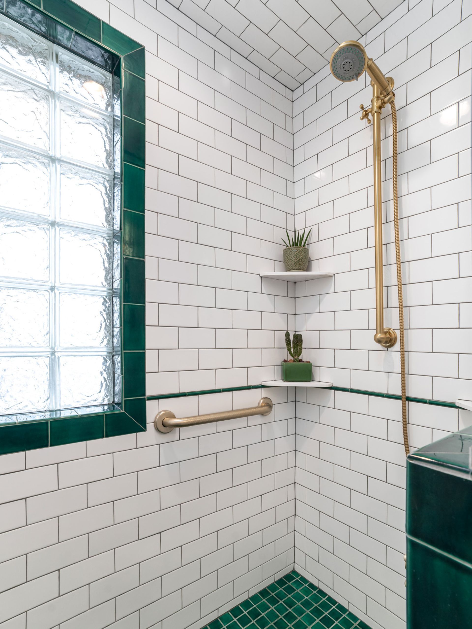 green bathroom design with gold brass shower fixture