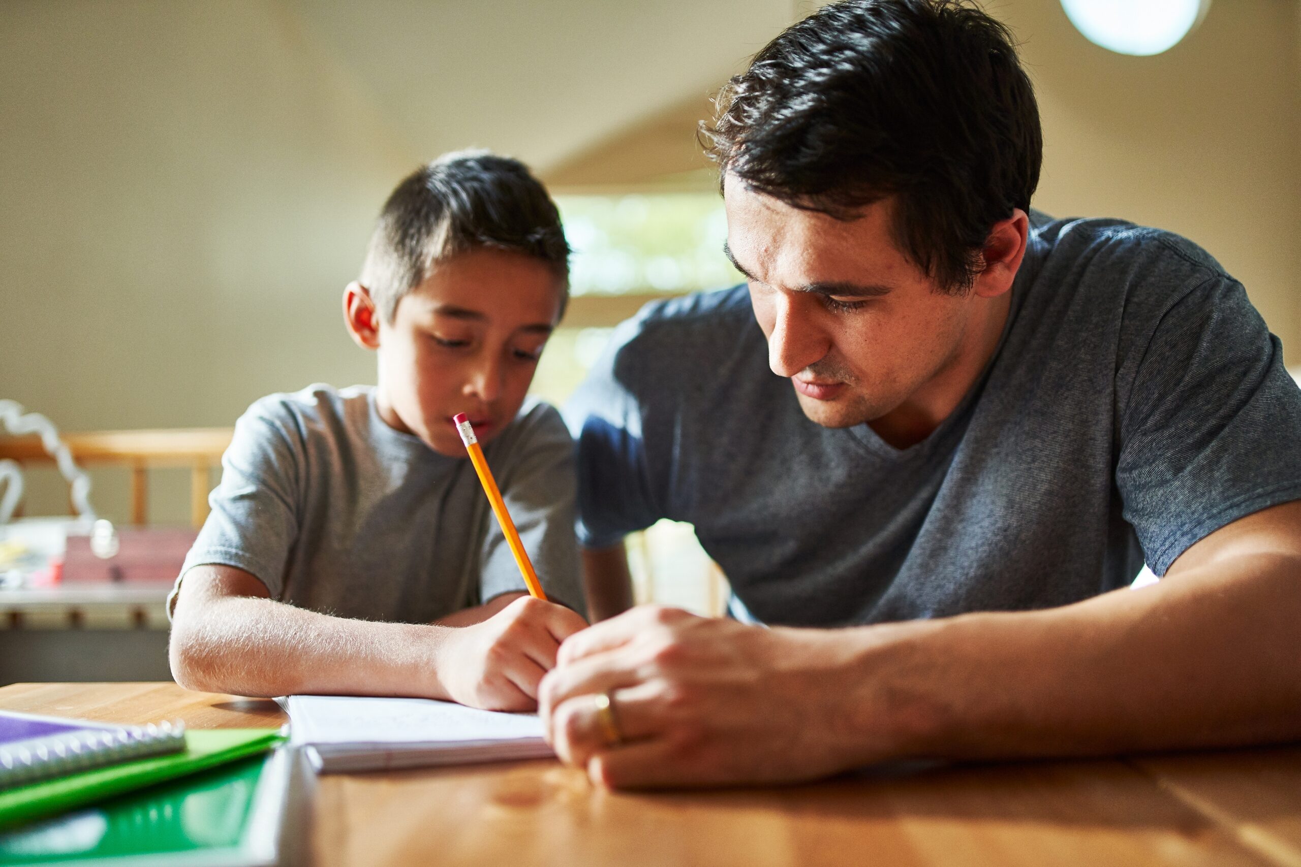 father and son doing homework together