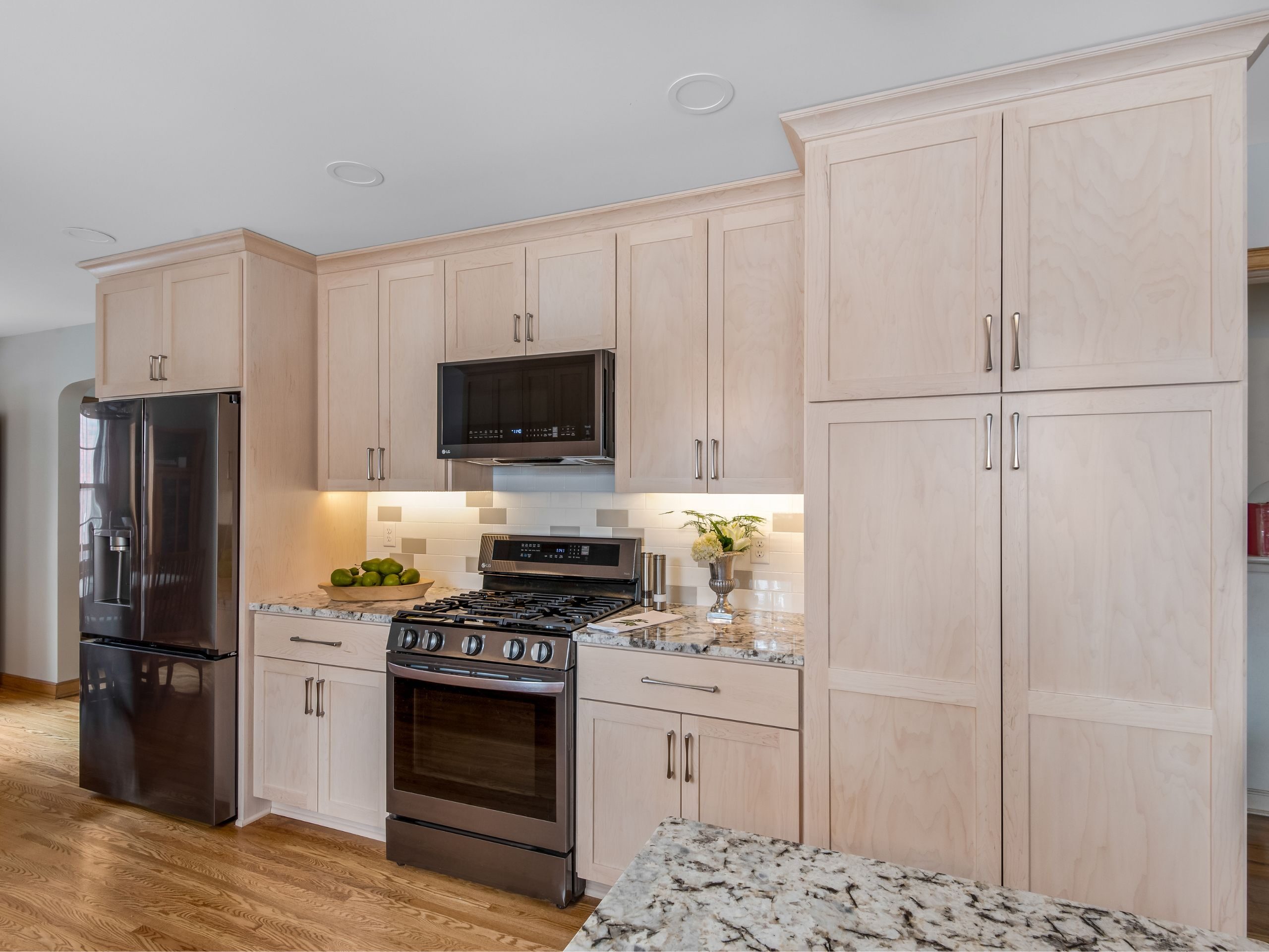 expanding kitchen into dining room allows for a wall of kitchen with oven, refrigerator and pantry