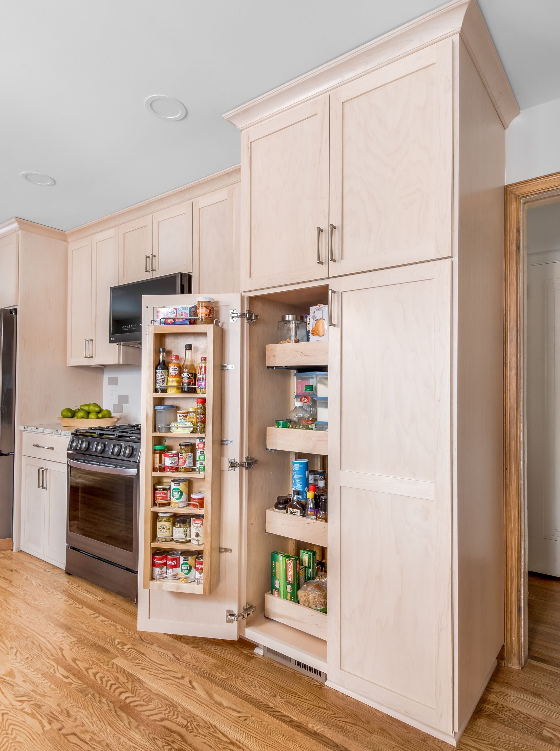 light stain maple cabinetry with pullout storage